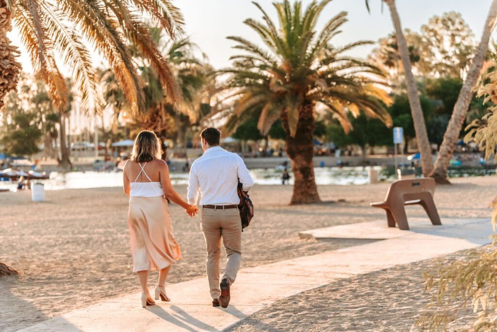 couple walking together at rotary park engagement session in lake havasu city