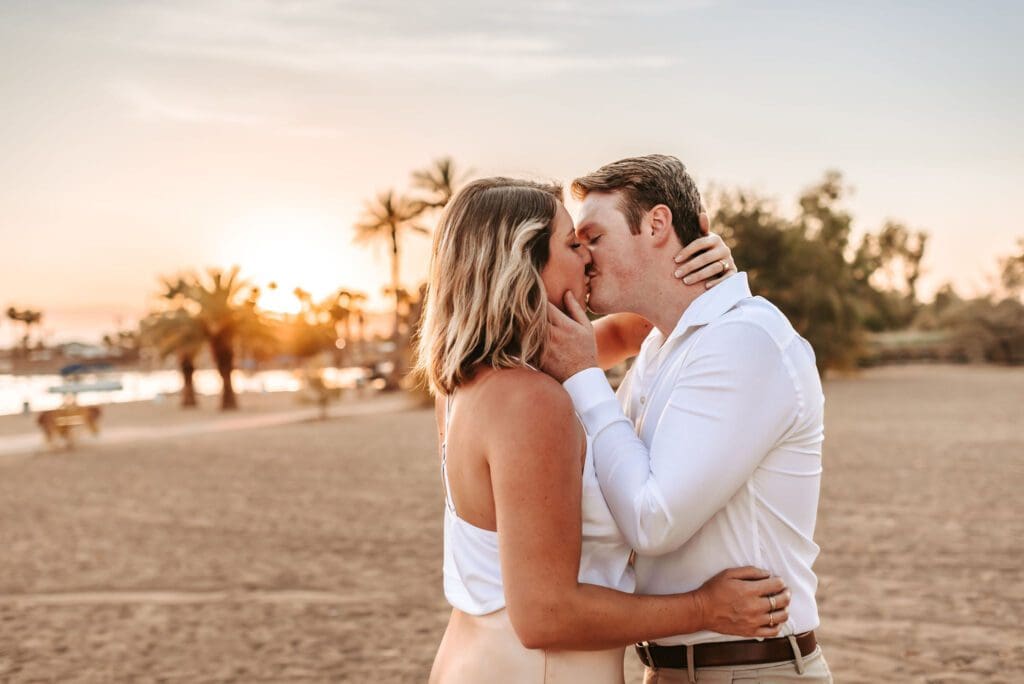 newly engaged couple kissing at rotary park