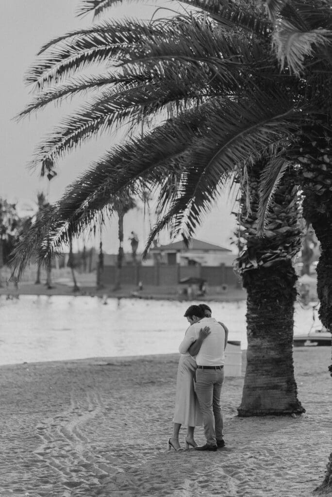 newly engaged couple hugging by lake havasu