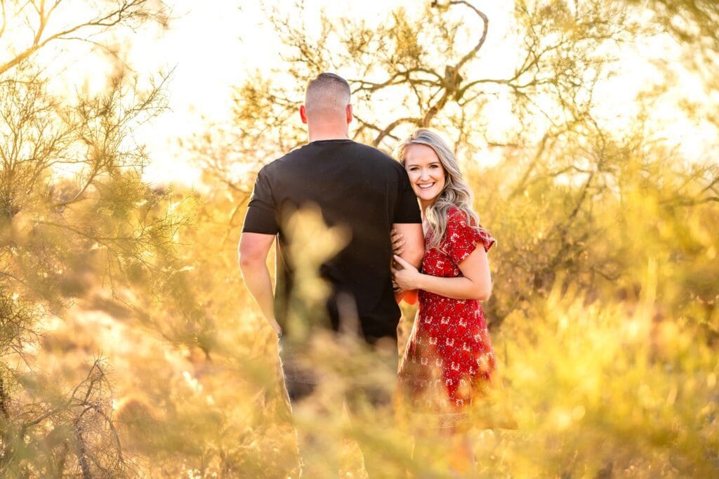 couple holding hands together in creosote bush