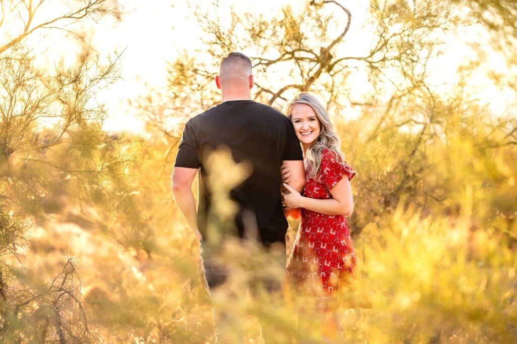 couple holding hands together in creosote bush