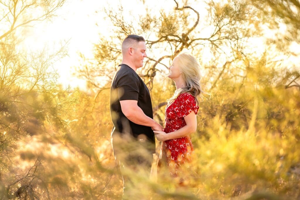 couple holding hands together in creosote bush