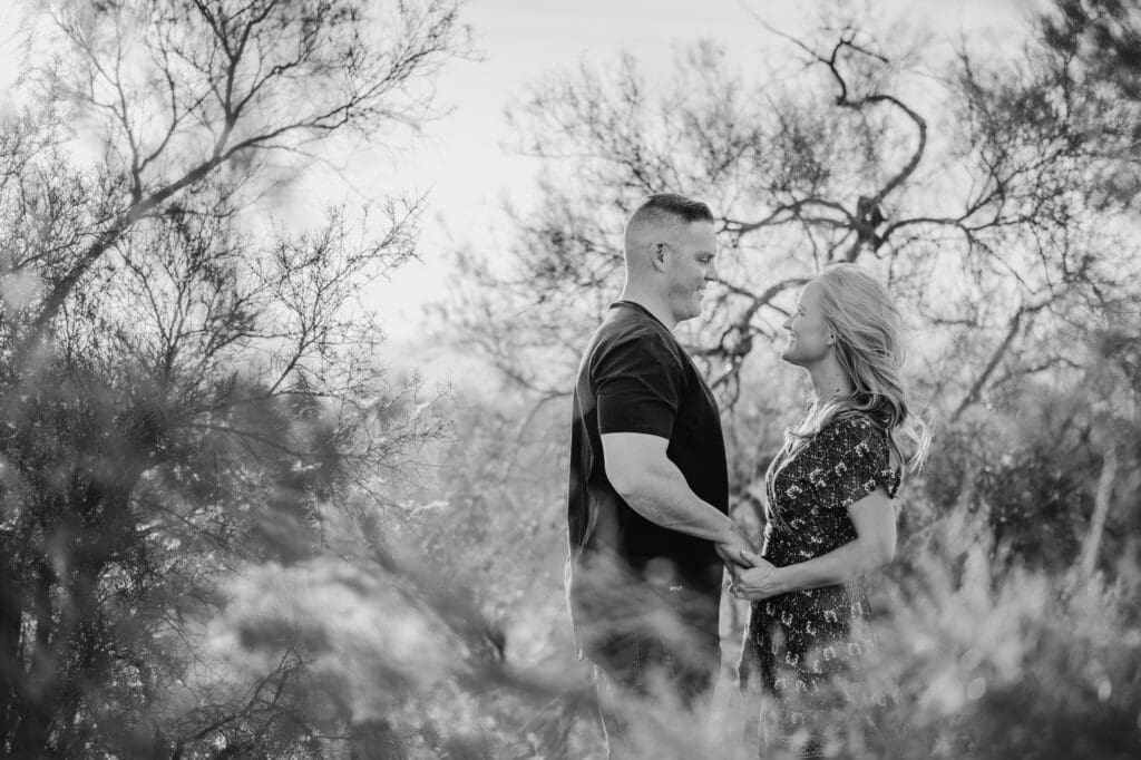 couple holding hands together in creosote bush