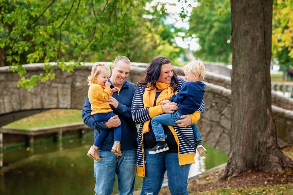 family of four wearing gold and navy blue