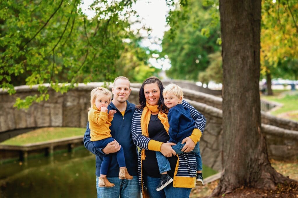 family of four wearing gold and navy blue
