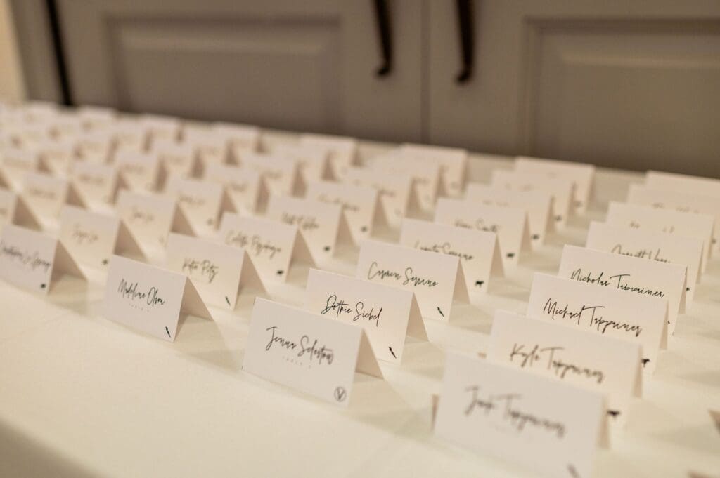 welcome table at wedding reception with seat assignment cards