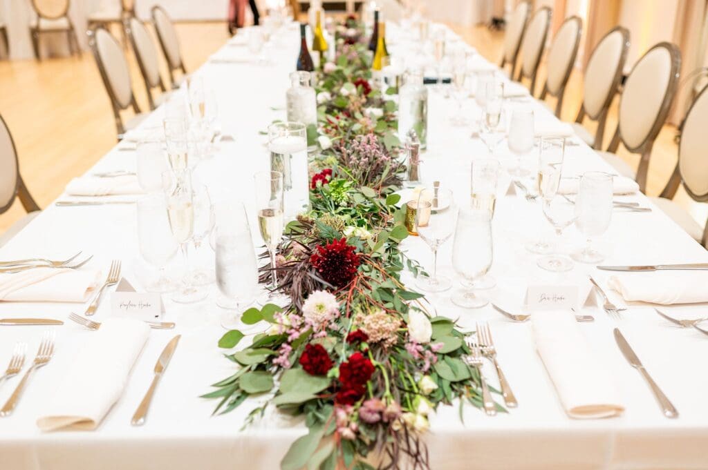 indoor wedding ceremony decor with floral table runners