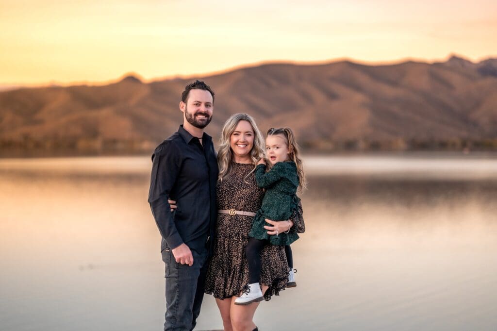 family photos in front of arizona lake at sunset