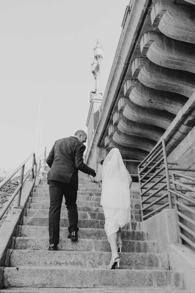 wedding photos going up the stairs at the london bridge