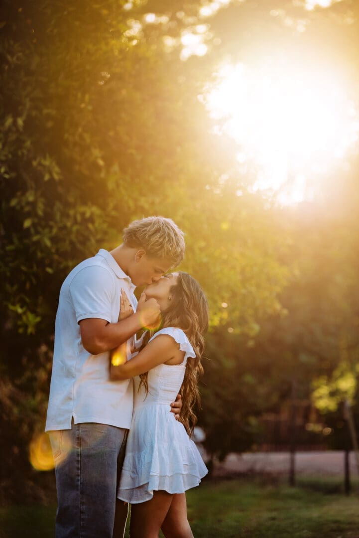 teen couple kissing with incredible golden hour light